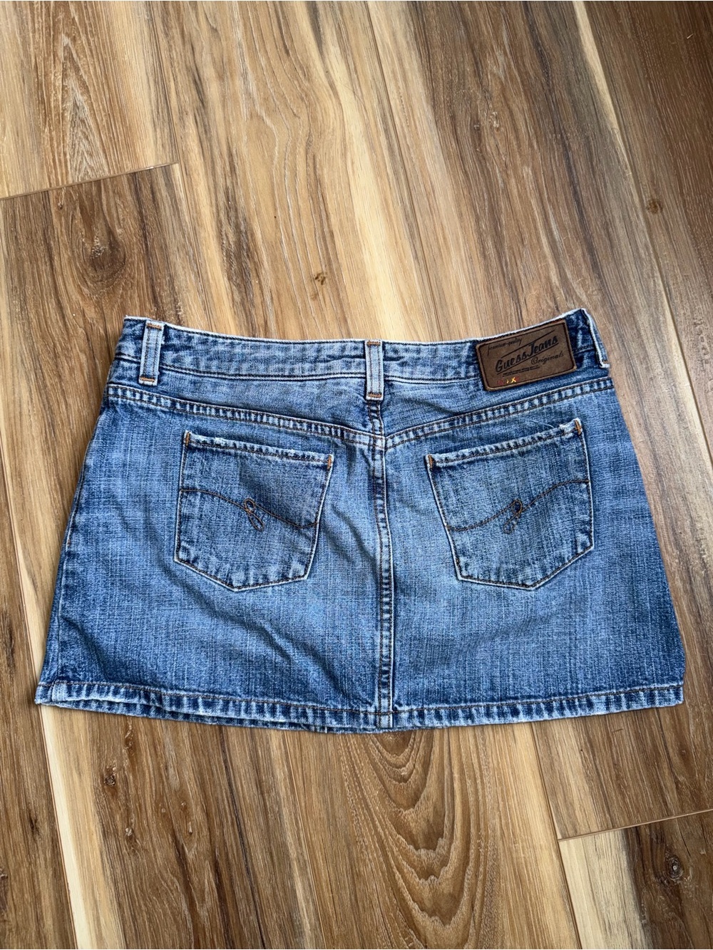 Vintage Guess Jeans denim mini skirt light wash with back pocket embroidery.